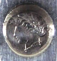 La tête de femme (Paris, Grosse garantie) se trouve sur le montant de la verseuse près de la prise de couvercle bouton côté gauche.